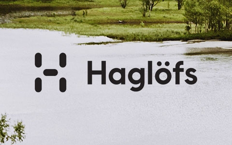 An image of a lake with the Haglofs logo in the centre
