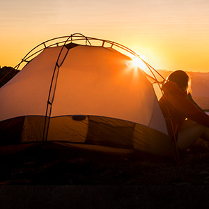 someone sat next to a tent